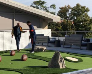 U of I football players enjoying the rooftop mini golf course at the Smith Football Center.