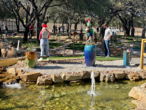 Masked players on the Cen-Tex Mini Golf course in central Texas.