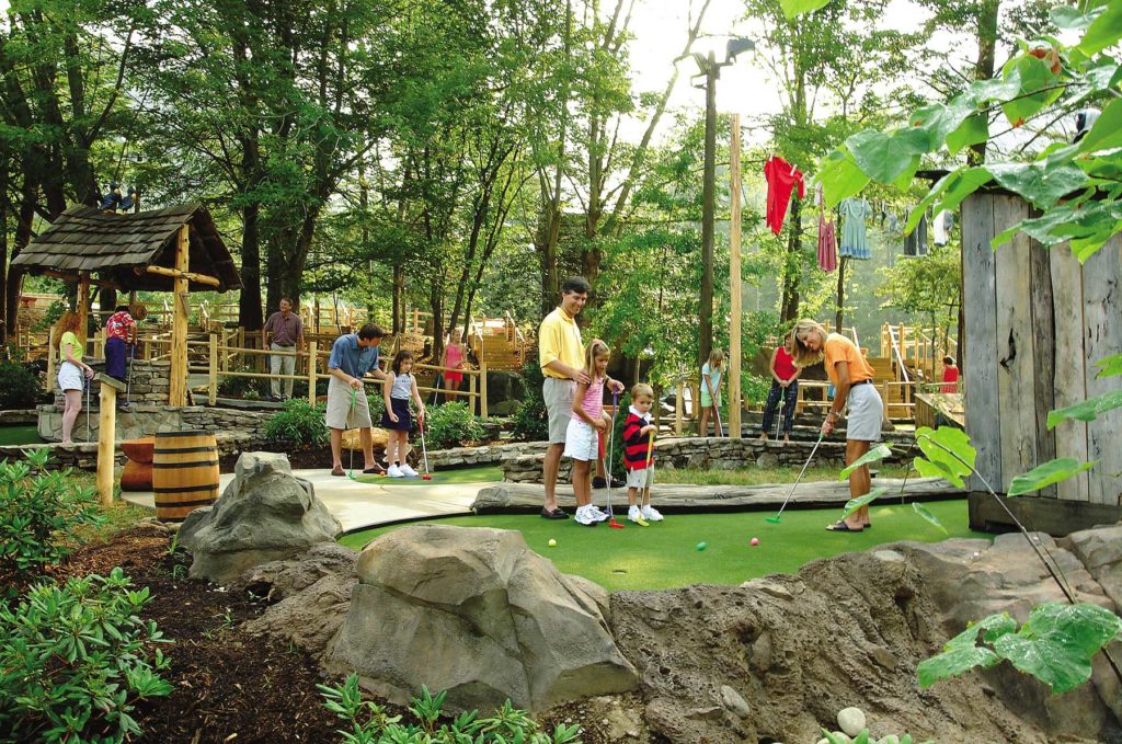 Family enjoying outdoor miniature golf course in Gatlinburg, TN