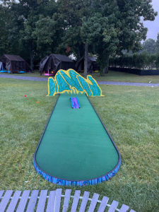 Long, straight putting green with large yellow and blue geometric obstacle placed over it, leaving space beneath for the ball to roll under, on the AGS-installed MiniLinks™ course in Montauk.