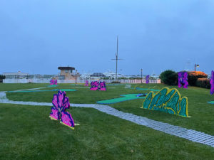 AGS portable mini golf course installed in Montauk, NY, with large colorful theme elements around each hole.