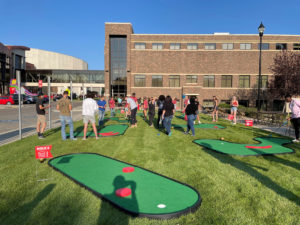 Surrounded by several other students, lone male lines up his shot on one of the various MiniLinks™ holes in Minot, North Dakota.