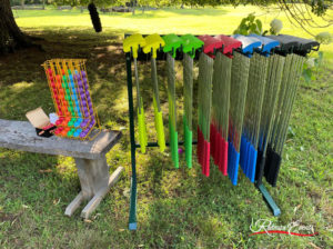 Various accessories lined up including solid-colored golf balls and Soft Putters™ in different colors and sizes hanging side-by-side.