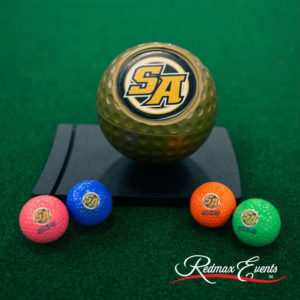Multiple golf balls in various colors placed on portable mini golf course at Saint Anthony’s High School in Melville, NY.