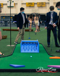 Mini golf ball pinging down AGS specialty obstacle on SplitShot® course while students from Saint Anthony’s High School watch.