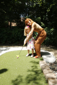 Mother and daughter pose for a picture on Adventure Golf & Sports Modular Advantage® Mini Golf course at the Veterans Memorial Park in Richfield, Minnesota.