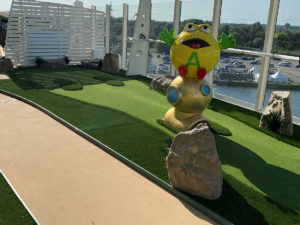 AGS mini golf hole along deck perimeter walkway, including a cartoon-like alien theme, on the AIDA Cosma Cruise Ship’s deck in Cadiz, Spain.