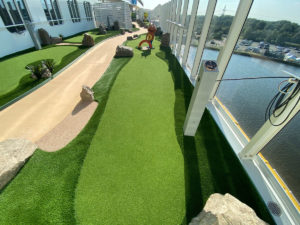 AGS mini golf hole with alien-like obstacle installed along deck perimeter walkway overlooking the Bay of Cadiz.