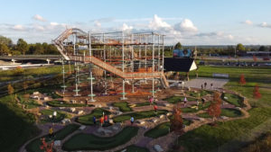Bird’s-eye view of the Ryze Adventure Park in Maryland Heights, showcasing a full mini-golf course, a 4-story tower, and a little ninja course.