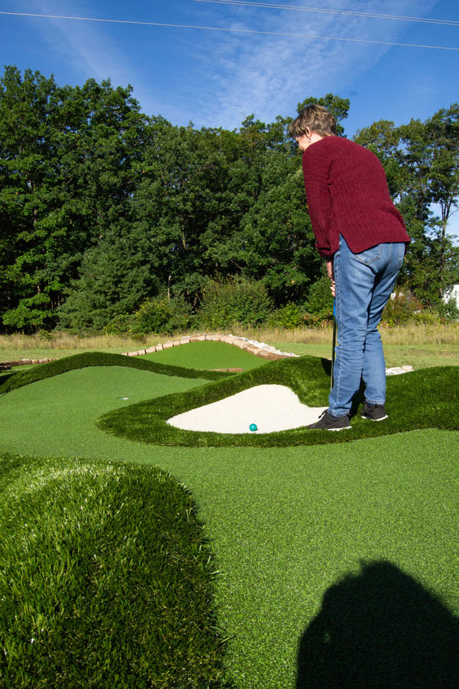 Player preparing to hit golf ball out of natural looking AGS Bunkers & Bumps™ sandtrap.