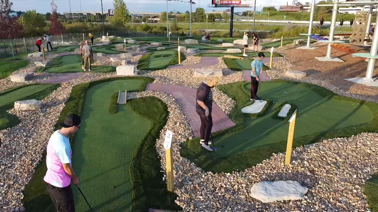 Players on several mini golf holes featuring contours, breaks and sand traps at Ryze Adventure Park