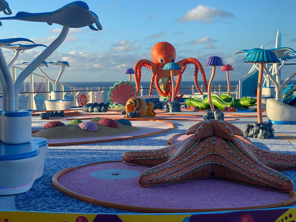 Giant octopus tentacles and a starfish are mini golf course obstacles on Wonder of the Seas 