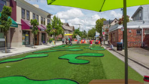 People playing on a MiniLinks™ course at a pop-up park along Bridge street in Delta, British Columbia