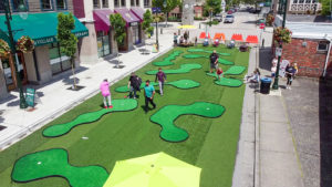 Overhead view of people playing miniature golf at a pop-up park in a business district of Delta, BC