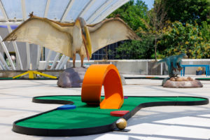 Rooftop Jurassic MiniLinks golf hole #8 with loop de loop among obstacles at the Brooklyn Children’s Museum