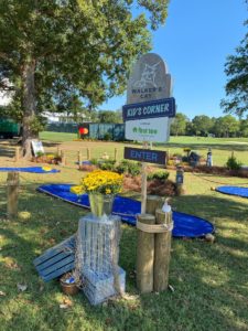 Crates, a bucket of flowers and a rope net decorate the 1st tee entrance to the mini golf course