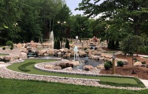 Players on a higher level overlook other mini golf holes among waterfalls and fountains at Club 24