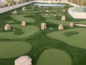 Caribe Resort mini golf has rough/smooth turf, faux sand bunkers and rocks creating a natural look