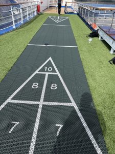 A shuffleboard court on the Carnival Elation made of AGS interlocking, permeable, patented panels