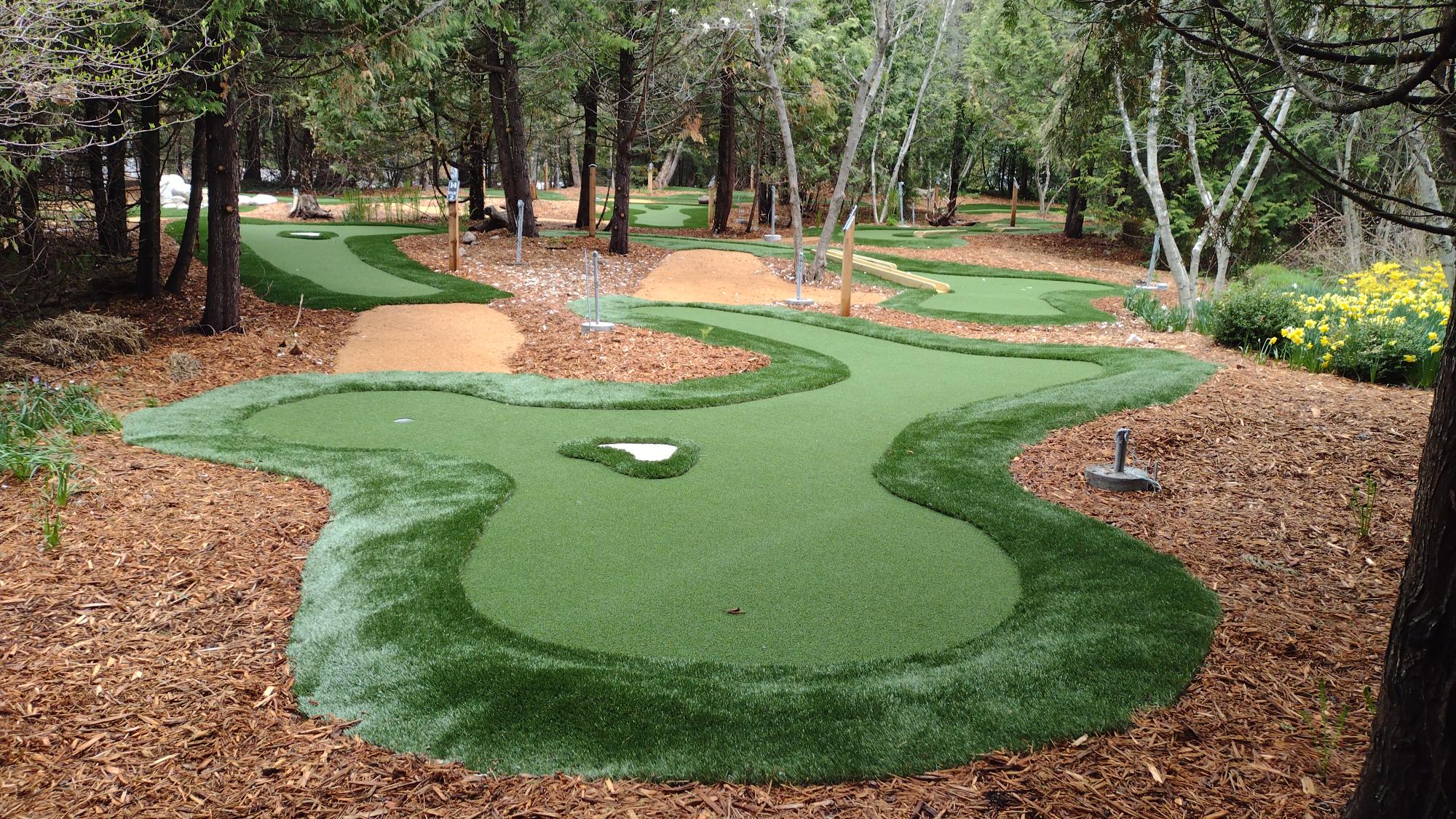 Grand Hotel mini golf winds through woodlands with sand traps and rough turf like regular golf