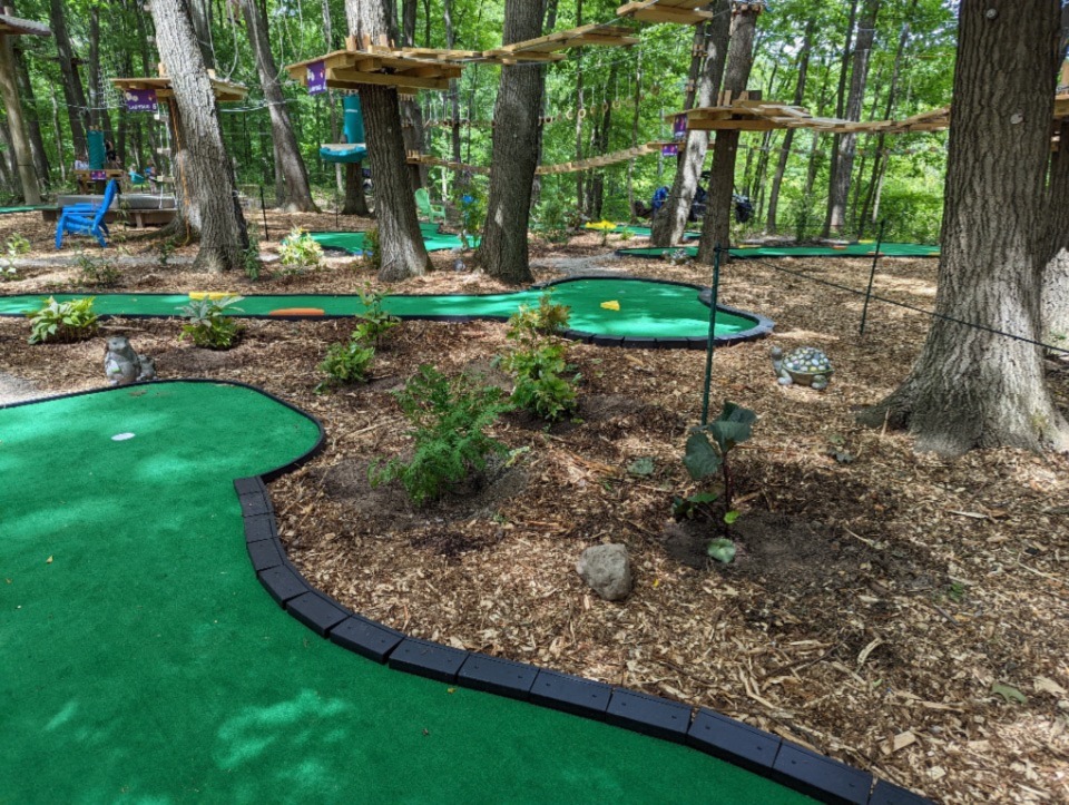 AGS AnyWhereLinks Jr® mini golf course under the elevated bridges and zip lines at a TreeRunner Park