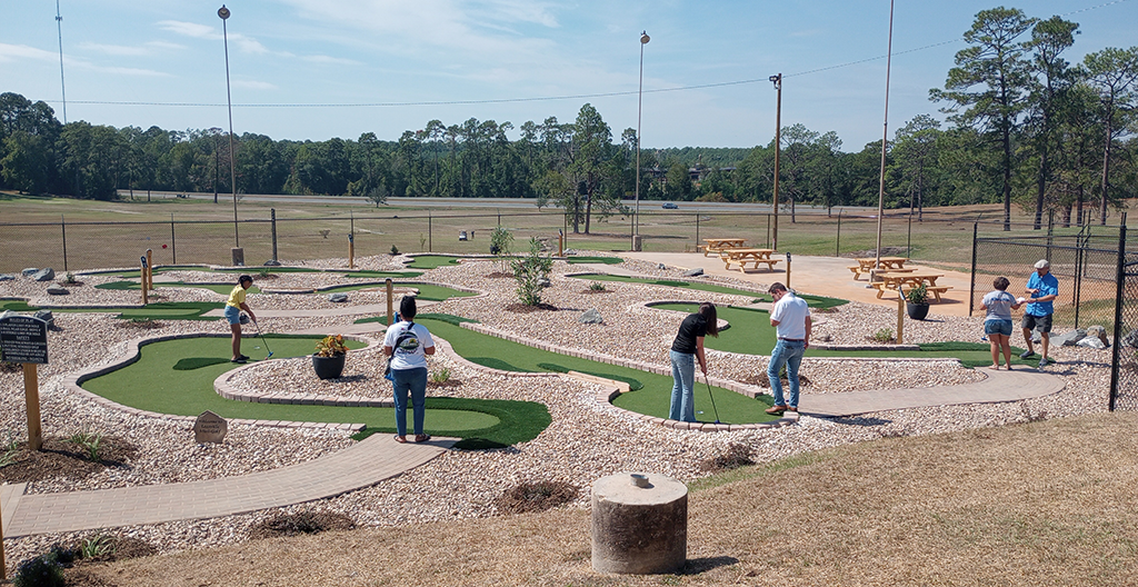 People playing on several City of Leesville, LA miniature golf course holes