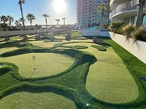 A rooftop mini golf links-style course at Caribe Resort with rolling terrain and faux sand bunkers 