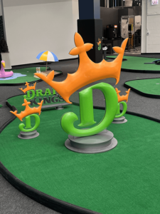 DraftKings online sports betting platform logo statuettes were obstacles on another mini golf hole
