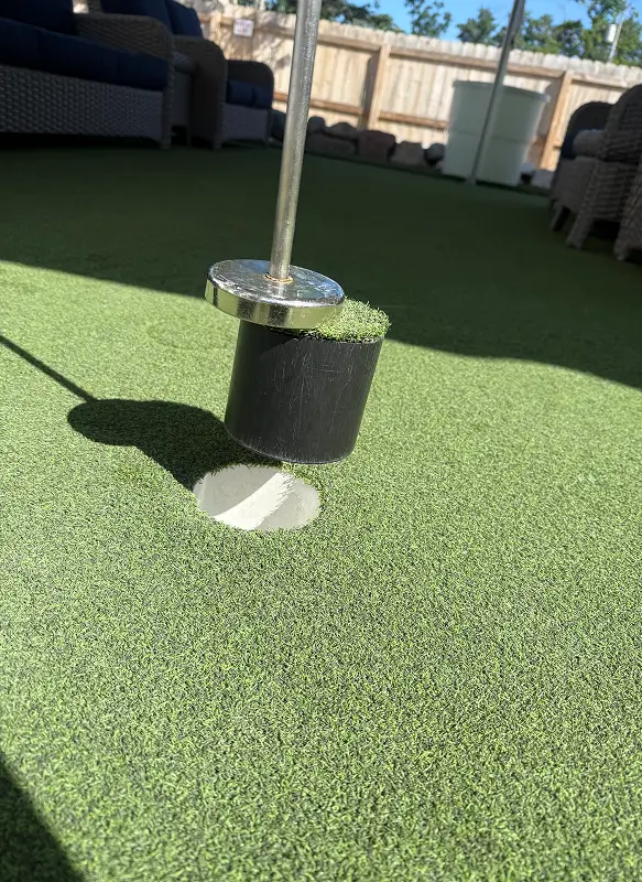 AGS hole cup remover lifts out a hole cup, turns it over and can restore a seamless putting surface