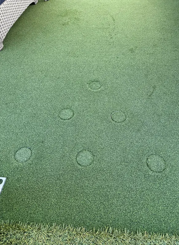 Customized pong mini golf where all cups have been turned over and a seamless turf surface restored