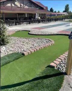 The Alpen Point mini golf course with its sloping terrain and game courts are adjacent to the restaurant and patio
