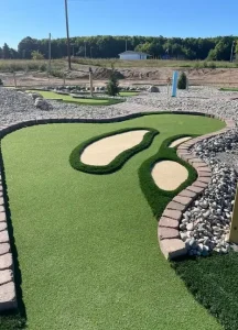 Faux sand traps and sloping terrain pose challenges on this AGS-designed miniature golf course