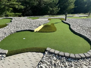 The narrow wooden bridge on this mini golf hole designed by AGS offers a shortcut to the cup