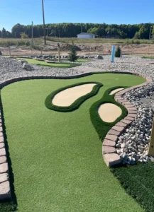 Faux sand traps and sloping terrain pose challenges on this AGS-designed miniature golf course