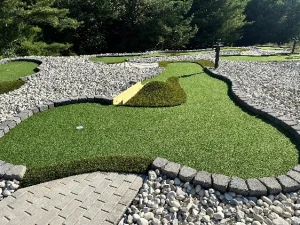 The narrow wooden bridge on this mini golf hole designed by AGS offers a shortcut to the cup